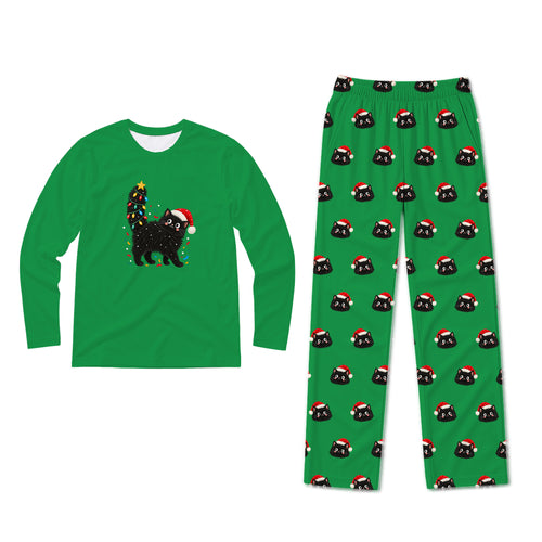 A two-piece Christmas pajama set on a plain white background. The long-sleeve shirt is bright green with a graphic of a black cat wearing a Santa hat next to a decorated Christmas tree.