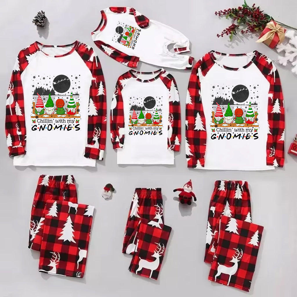 A family of four wearing matching Christmas-themed pajamas with the text 'Christmas Cousin/Cousin Crew' on the front, posed in a festive living room with a decorated Christmas tree and holiday wreath.