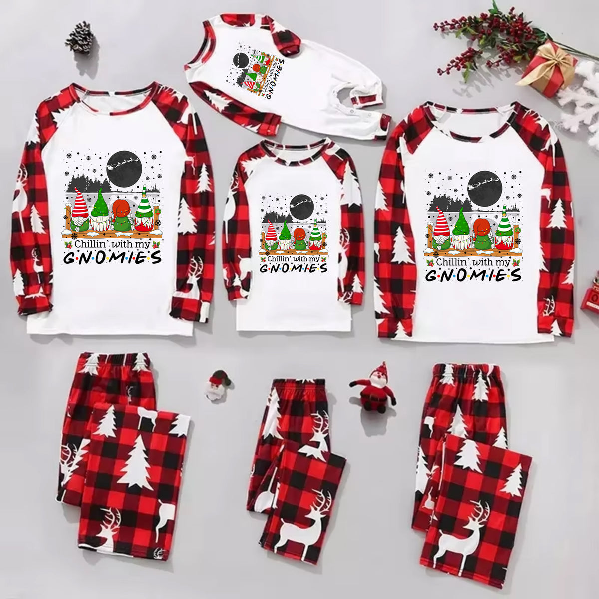 A family of four wearing matching Christmas-themed pajamas with the text 'Christmas Cousin/Cousin Crew' on the front, posed in a festive living room with a decorated Christmas tree and holiday wreath.
