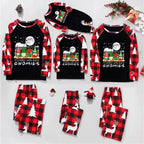 A flat lay of a Christmas-themed pajama set for multiple sizes, featuring long-sleeve raglan shirts with red and black buffalo plaid sleeves and a festive gnome graphic on the front, paired with matching plaid and white reindeer-patterned pants.