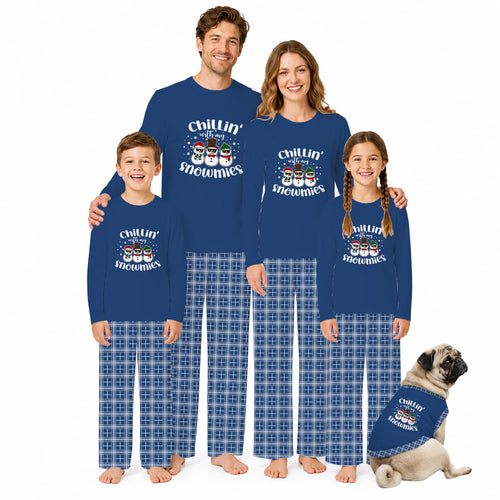 A family of four and a dog wearing matching royal blue long-sleeve pajamas with a snowman graphic and blue plaid pants, posed against a plain white background.