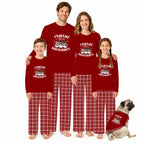 A family of four and a dog wearing matching red Christmas pajamas with 'Chillin' Snowman' graphics and red plaid pants, posed together on a white background.