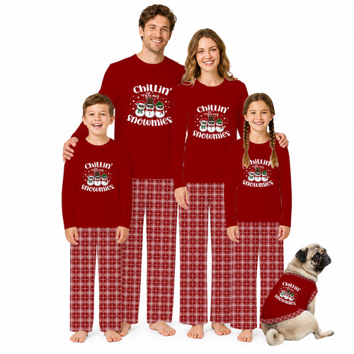 A family of four and a dog wearing matching red Christmas pajamas with 'Chillin' Snowman' graphics and red plaid pants, posed together on a white background.
