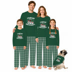 A family of four and a dog wearing matching dark green long-sleeve pajamas with 'Chillin' Snowman' graphics and green plaid pants, posed against a plain white background.
