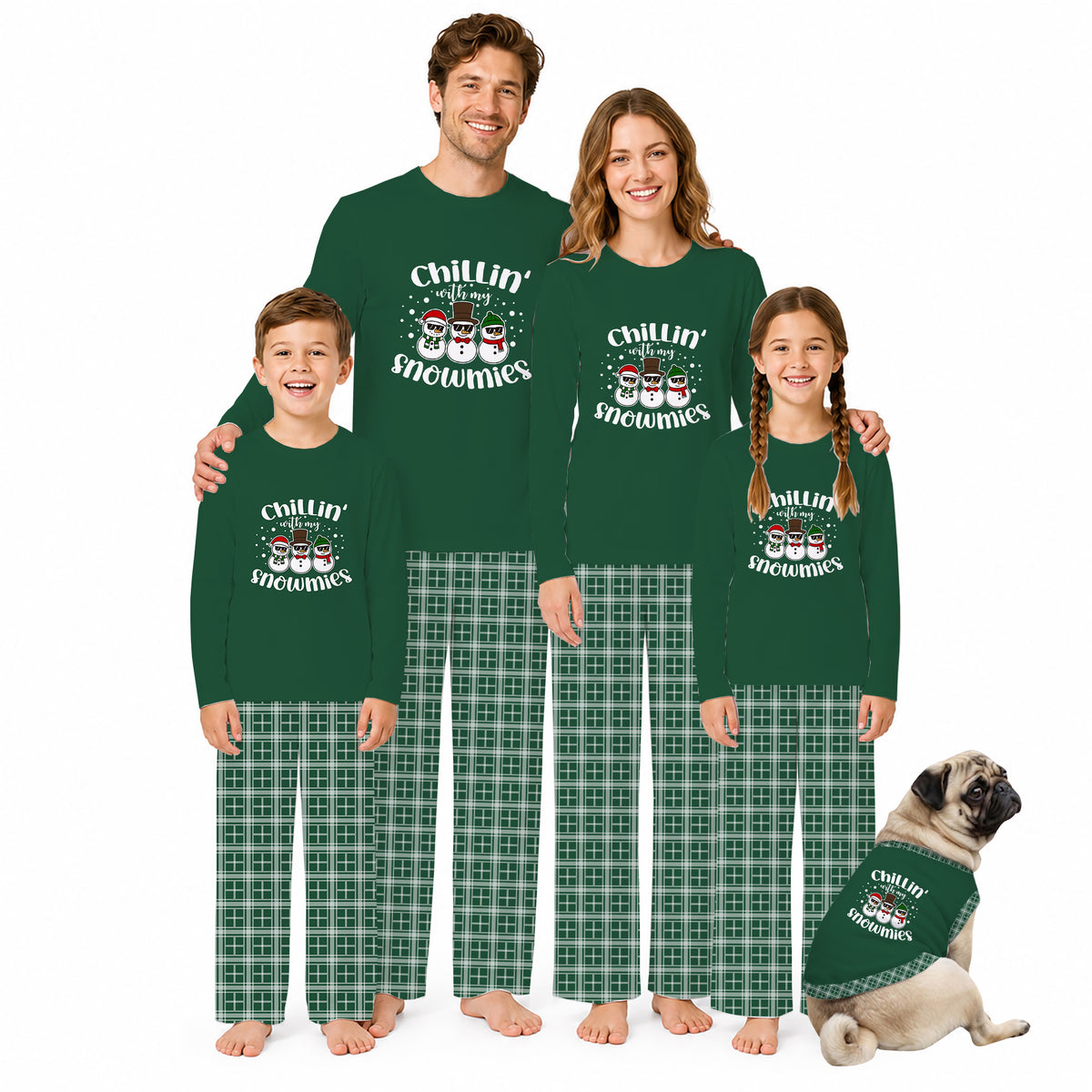 A family of four and a dog wearing matching dark green long-sleeve pajamas with 'Chillin' Snowman' graphics and green plaid pants, posed against a plain white background.
