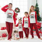 A family of four and a dog wearing matching Christmas-themed pajamas in a living room decorated for the holidays. The pajamas are white with red long sleeves and red-and-black buffalo plaid pants, featuring a graphic that reads 'Christmas 2026 Cousin Creep'.