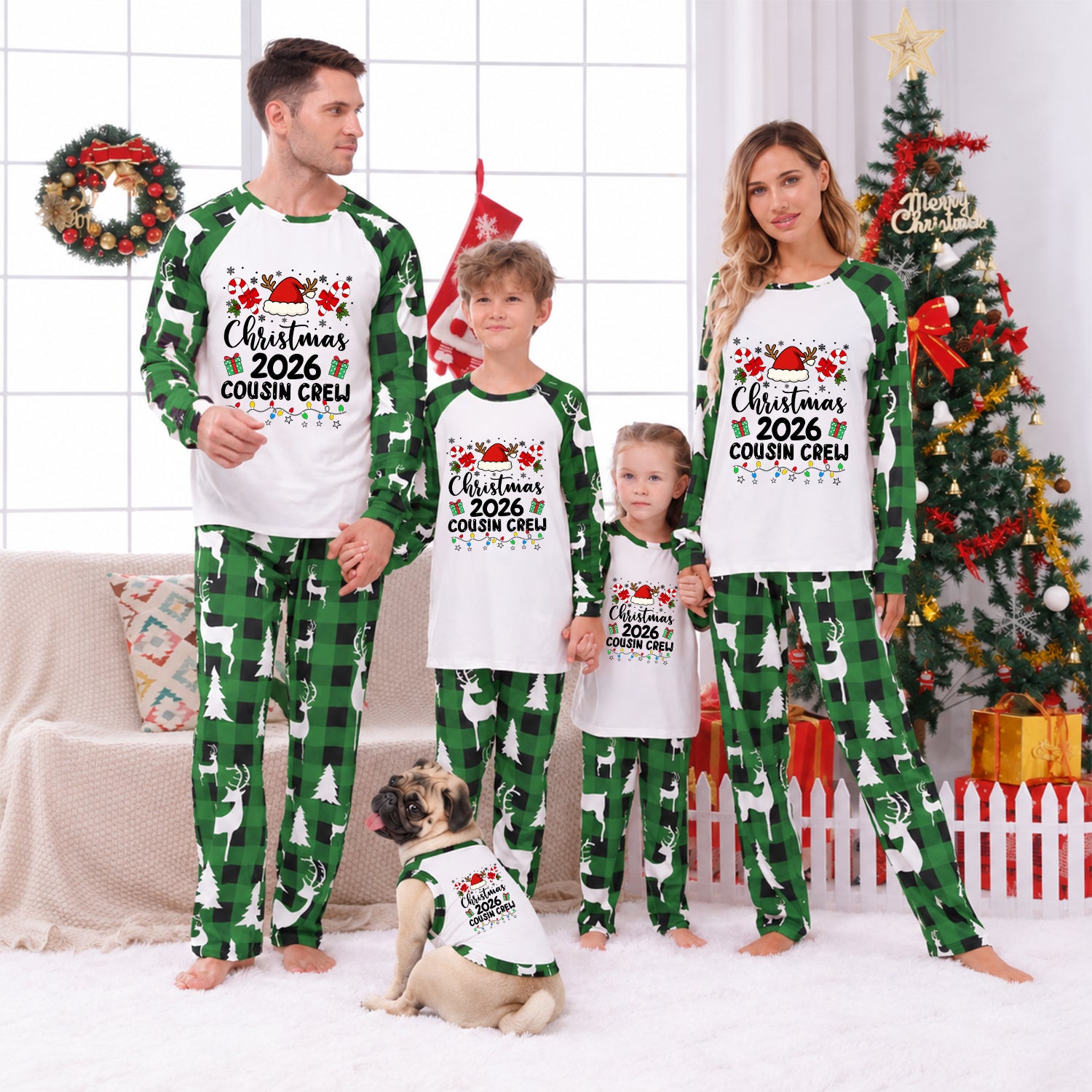 A family of four wearing matching Christmas-themed pajamas stands in a living room decorated for the holidays. The pajamas are white long-sleeve tops with green raglan sleeves and green plaid pants, featuring a graphic that reads 'Christmas 2026 Cousin Creep'.