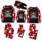A matching family Christmas pajama set shown in three sizes, including long-sleeve raglan shirts and pants. The set features a black shirt with red and white plaid sleeves, a festive graphic on the chest, and white reindeer and Christmas tree prints on the pants.