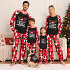 A family of four wearing matching Christmas-themed long-sleeve pajamas stands in a living room with a couch, tree, and dog. The pajamas have a black chest panel with white text reading 'Christmas 2026 Cousin Creep' and a red-and-black buffalo plaid pattern with white reindeer and tree motifs.