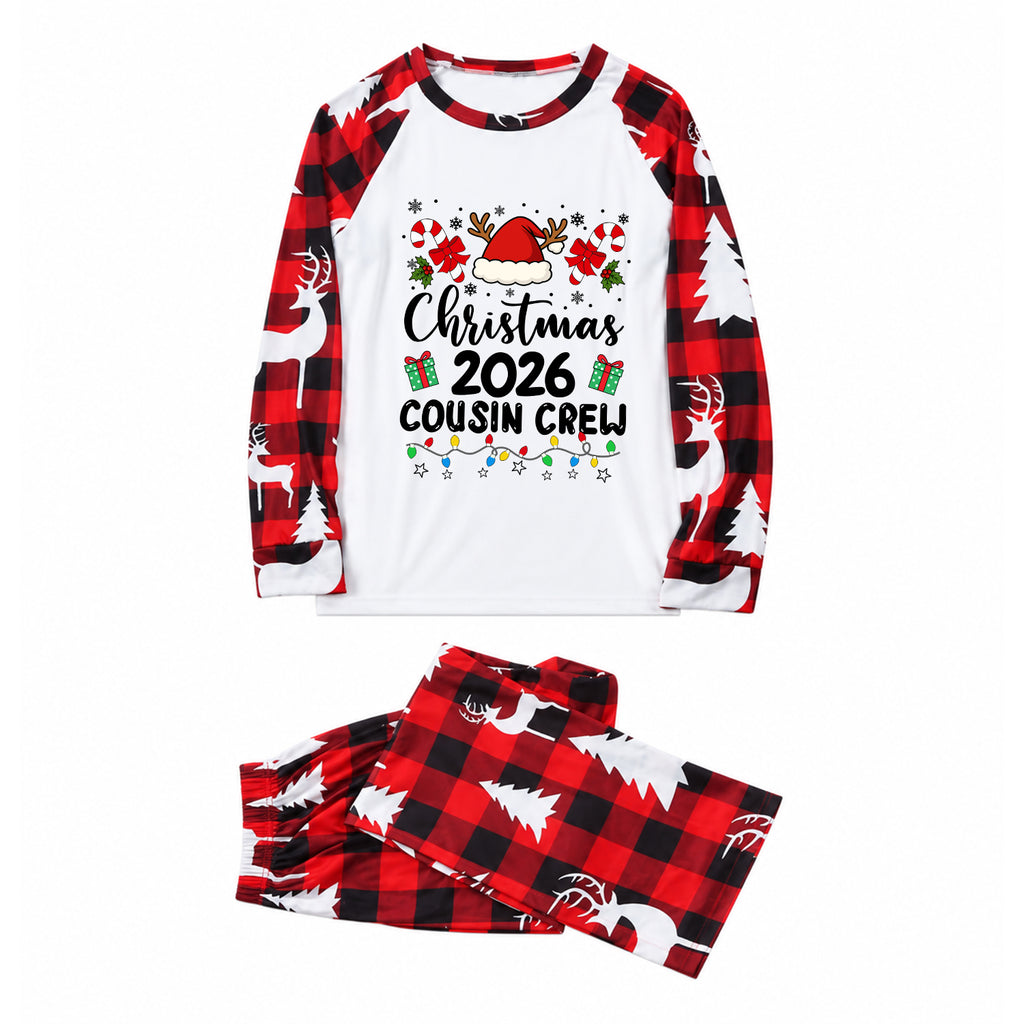 A two-piece Christmas-themed pajama set featuring a long-sleeve top and matching pants. The top is white on the chest with a festive graphic reading 'Christmas 2026 Cousin Crew' surrounded by a Santa hat, holly, and holiday lights, and has red-and-black buffalo plaid raglan sleeves with white reindeer prints.