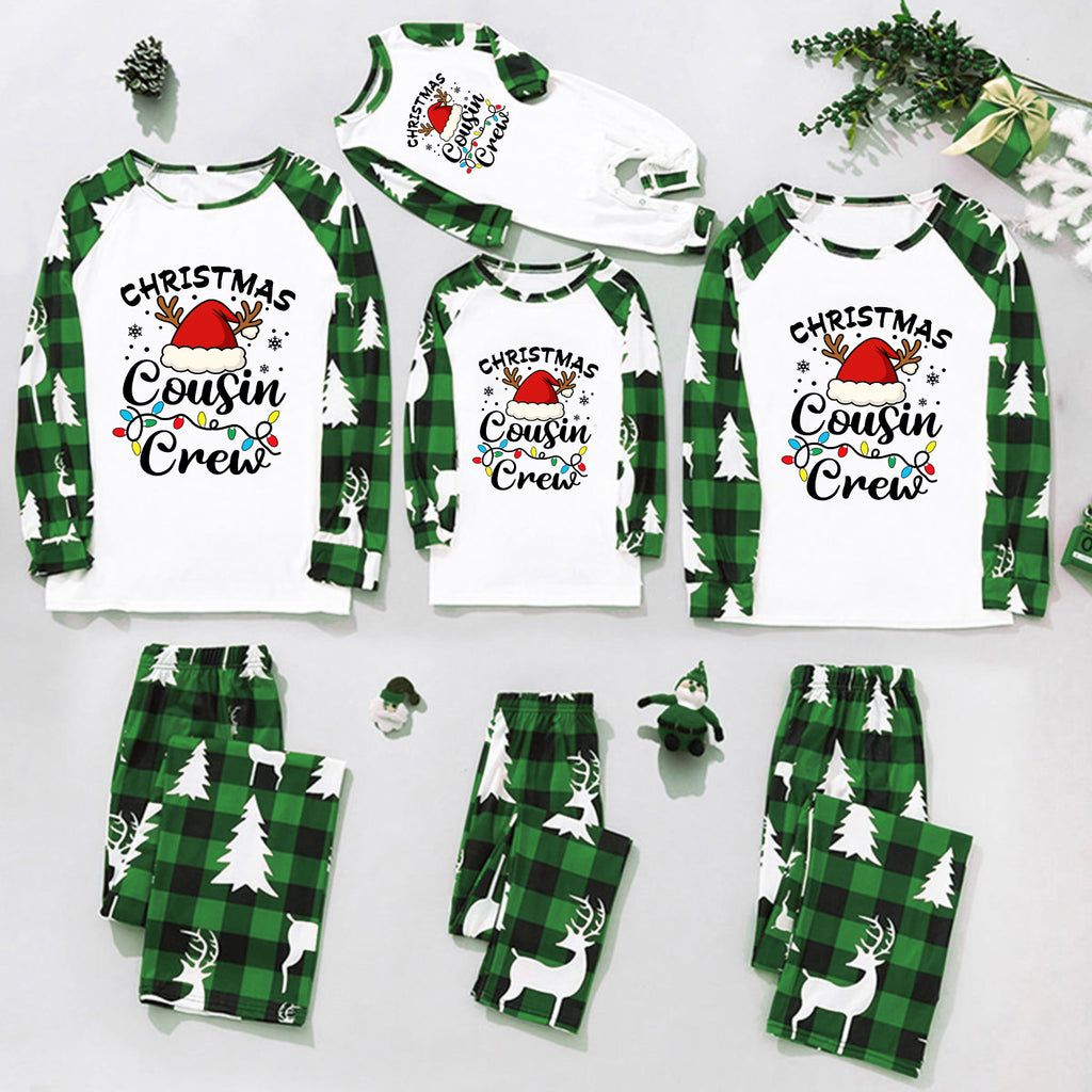 A coordinated Christmas family pajama set arranged on a light gray background, including long-sleeve tops and matching pants in green plaid and white with holiday graphics such as Santa hats, trees, reindeer, and the text 'Christmas Cousin Crew.'.