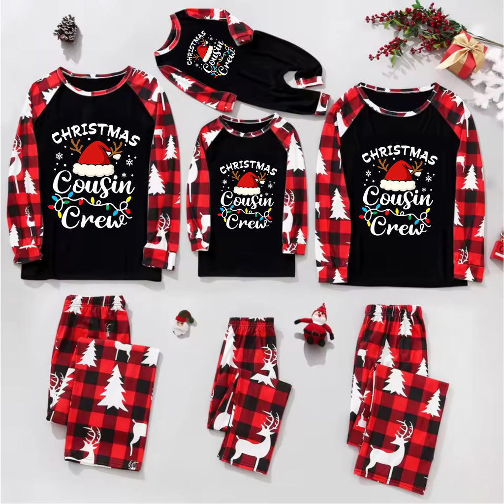 A matching family Christmas cousin crew pajama set displayed flat on a white background, including long-sleeve shirts and pants for different sizes. The shirts are black with red and black buffalo plaid sleeves and a white graphic reading 'Christmas Cousin Crew' with a Santa hat and holiday lights.