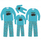 Three sizes of matching family Christmas pajamas displayed on invisible mannequins against a white background. The set includes a long-sleeve crewneck shirt and matching patterned pants in turquoise blue, featuring a 'CHRISTMAS SPILTER MALL' graphic with a sleigh and reindeer on the chest, and a small red and green holiday print all over the pants.