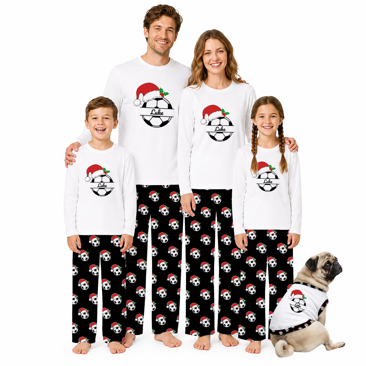 A family of four and a dog wearing matching white long-sleeve pajamas with a black soccer ball pattern and Santa hats, posed against a plain white background.