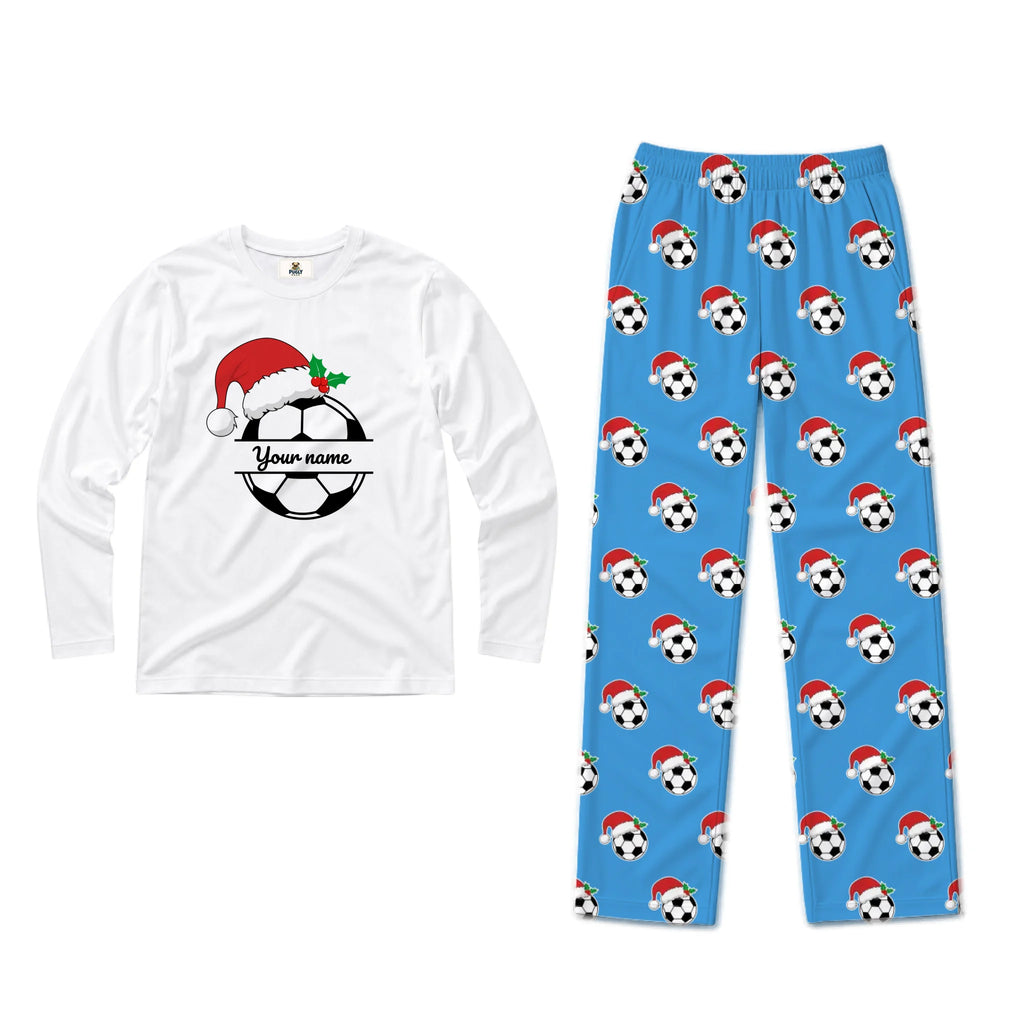 A two-piece pajama set on a white background, featuring a white long-sleeve shirt with a customizable soccer ball and Santa hat graphic, and blue pants with an all-over print of soccer balls wearing Santa hats.