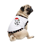 A fawn pug dog wearing a white pet shirt with a black patterned trim. The shirt features a soccer ball graphic decorated with a red Santa hat, green holly leaves, and the name 'Dane' in script across the center.