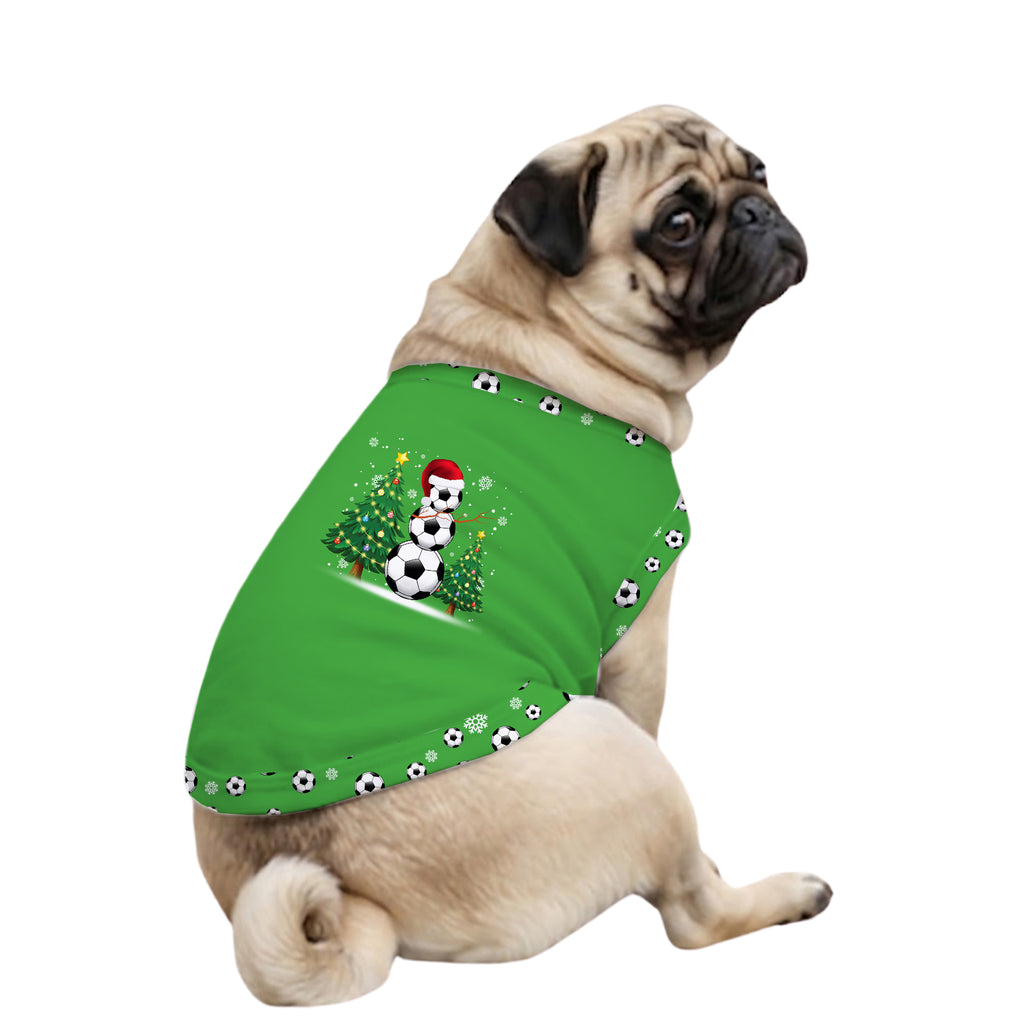 A fawn pug dog wearing a bright green pet sweater with a festive snowman and soccer ball graphic on the back, set against a plain white background.