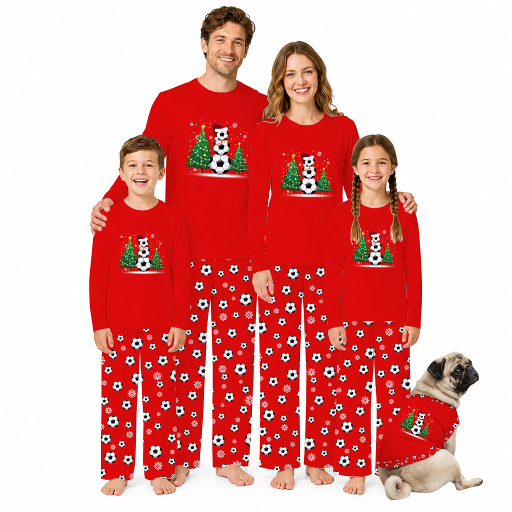 A family of four and a dog wearing matching red Christmas soccer-themed pajamas, standing together against a plain white background.
