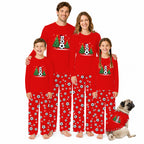 A family of four and a dog wearing matching red Christmas soccer-themed pajamas, standing together against a plain white background.