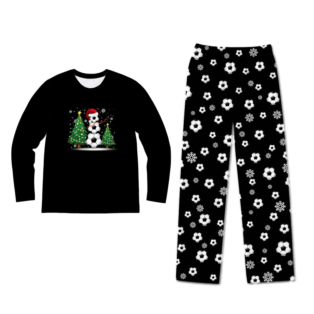 A two-piece kids' pajama set on a plain white background. The long-sleeve shirt is black with a festive graphic of a snowman wearing a red Santa hat and scarf next to a soccer ball.