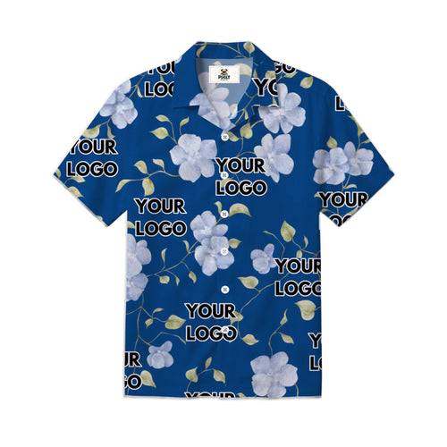 A short-sleeve button-up camp collar shirt in royal blue, featuring a white and light purple floral pattern with green leaves and repeating 'YOUR LOGO' placeholder text, shown on a plain white background.