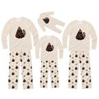 Three matching family Christmas pajama sets in different sizes, featuring cream-colored long-sleeve tops with a black-and-white striped Christmas tree graphic and patterned pants. The pants have holly and pinecone motifs, with the largest set having dark brown pinecones and the smaller sets having dark brown pinecones with green holly accents.