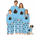 A family of five wearing matching light blue long-sleeve pajamas with a Christmas tree and striped animal print, standing together on a white background, with a small pug dog wearing a matching pajama set beside them.