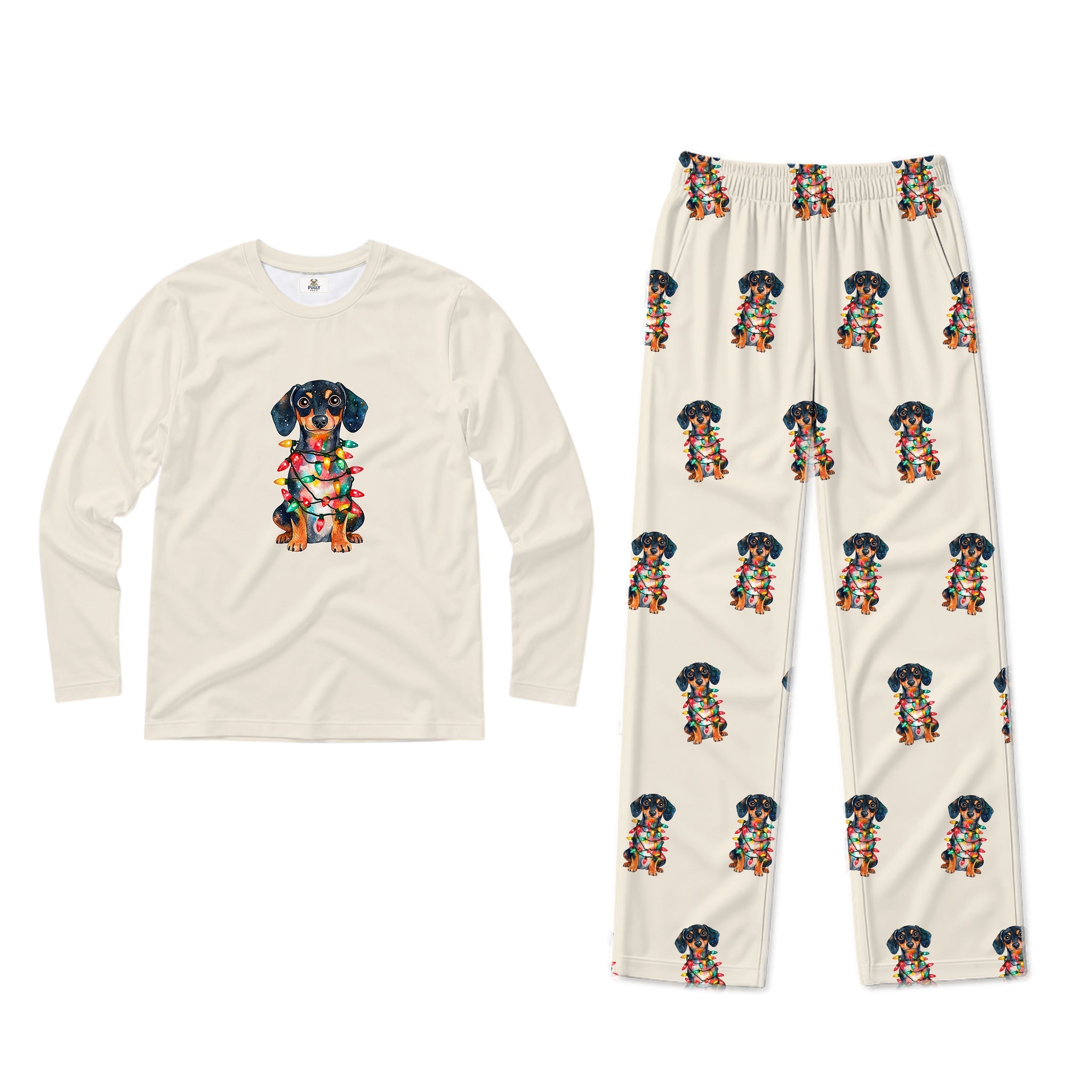 A two-piece pajama set on a plain White background, featuring a Cream long-sleeve shirt with a colorful dachshund graphic on the chest and matching Cream pants with an all-over dachshund print.