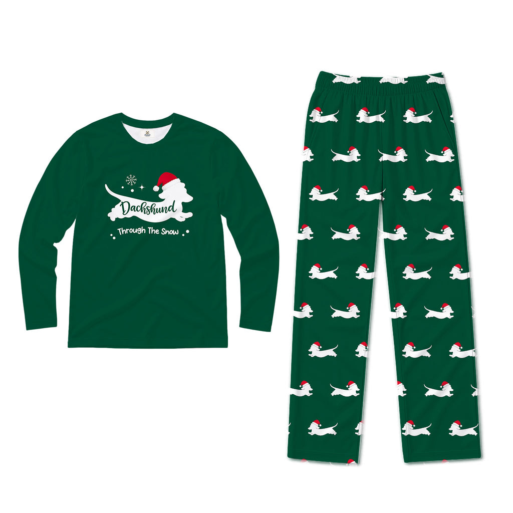 A two-piece Christmas-themed pajama set featuring a dark Green long-sleeve shirt with a White dog silhouette and the text 'DuckHunter Through The Snow' with a Santa hat, and matching dark Green pants with an all-over print of White dogs wearing Red Santa hats.