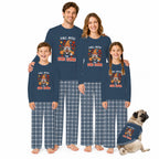 A family of four and a dog wearing matching long-sleeve pajamas with a Thanksgiving-themed graphic that reads 'FALL INTO END ZONE' and plaid pants, posed against a plain white background.