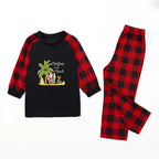 A two-piece children's pajama set laid flat on a White background. The long-sleeve top is Black on the front with Red and Black plaid sleeves and a 'Christmas on the Beach' graphic.