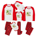 A matching family pajama set displayed on a White background, including long-sleeve raglan shirts and pants in Red and White with a tropical Santa graphic, plus Red and Black buffalo plaid pants and a matching bib.
