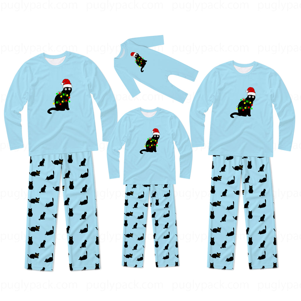 Three sizes of matching family pajama sets shown on a white background. Each set includes a light blue long-sleeve top with a black cat wearing a Christmas tree and Santa hat graphic, paired with light blue pants covered in a black cat print.