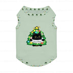 A light sage Green pet tank top featuring a festive Christmas tree graphic with a Black cat and a 'Merry Christmas' banner. The tank top is decorated with small Christmas tree prints along the collar and sleeve cuffs, and is shown against a White background with faint 'puglypack.