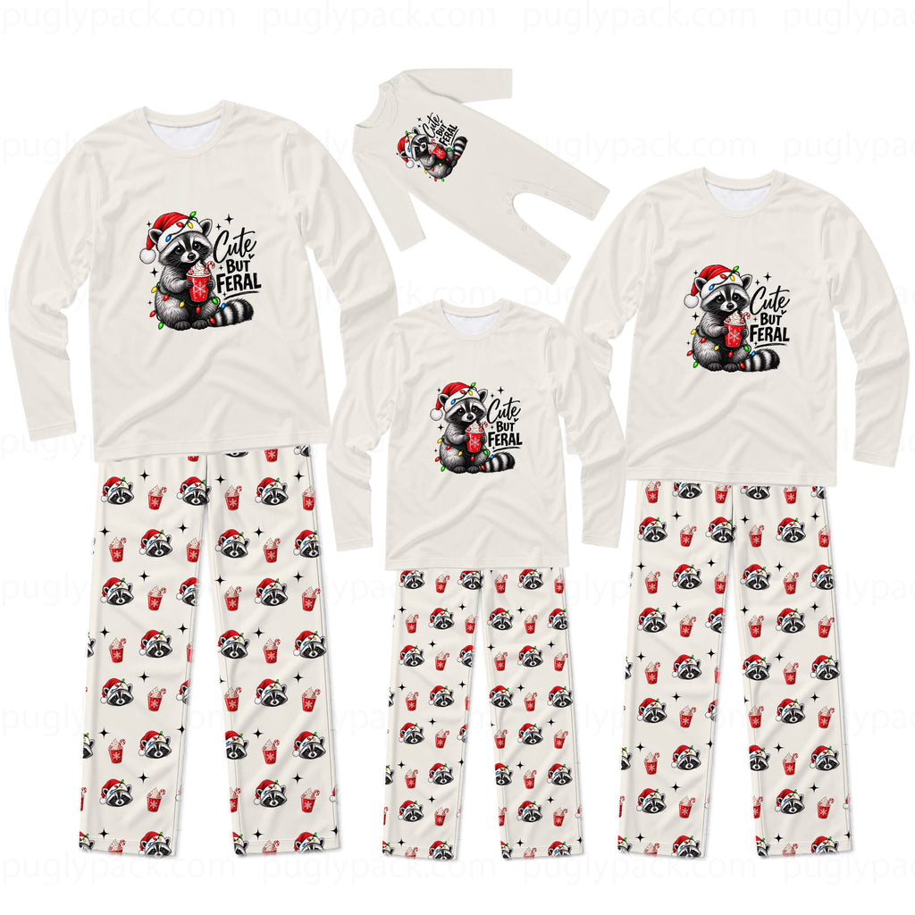 A matching family Christmas pajama set with long-sleeve shirts and pants in cream white. The shirts feature a cute raccoon wearing a Santa hat and holding a red mug with the text 'Cute But FERAL'.
