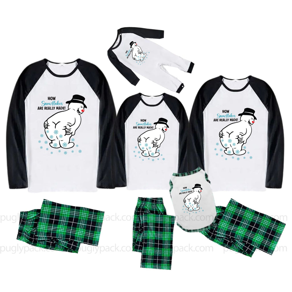 Three matching family pajama sets shown on a White background, each consisting of a long-sleeve raglan shirt and shorts. The shirts are White with Black sleeves and a cartoon polar bear graphic with the text 'HOW'S YOUR DAY BE REALLY MANDATORY'.