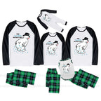 Three matching family pajama sets shown on a White background, each consisting of a long-sleeve raglan shirt and shorts. The shirts are White with Black sleeves and a cartoon polar bear graphic with the text 'HOW'S YOUR DAY BE REALLY MANDATORY'.