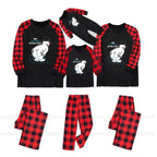 Three matching family Christmas pajama sets shown on a White background, including long-sleeve shirts and pants. The shirts are Black with Red buffalo plaid sleeves and a White cartoon snowman graphic with the text 'HOW'S EVERYTHING?' and 'DO WE HAVE TO WAIT?'.