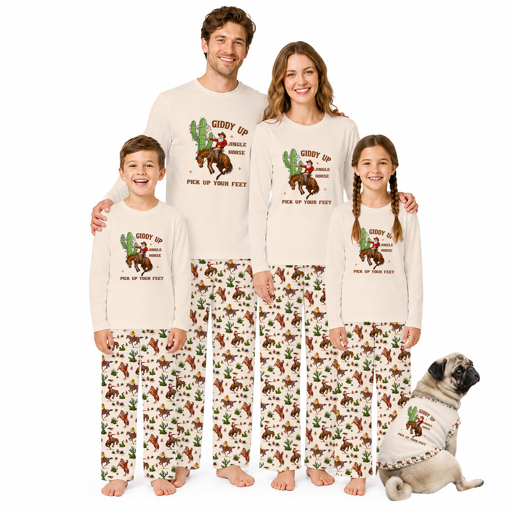 A family of four and a dog modeling matching long-sleeve pajamas with a western 'Giddy Up Pick Up Your Feet' cactus and cowboy graphic, on a solid white background.