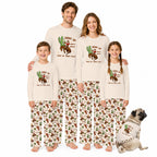 A family of four and a dog modeling matching long-sleeve pajamas with a western 'Giddy Up Pick Up Your Feet' cactus and cowboy graphic, on a solid white background.