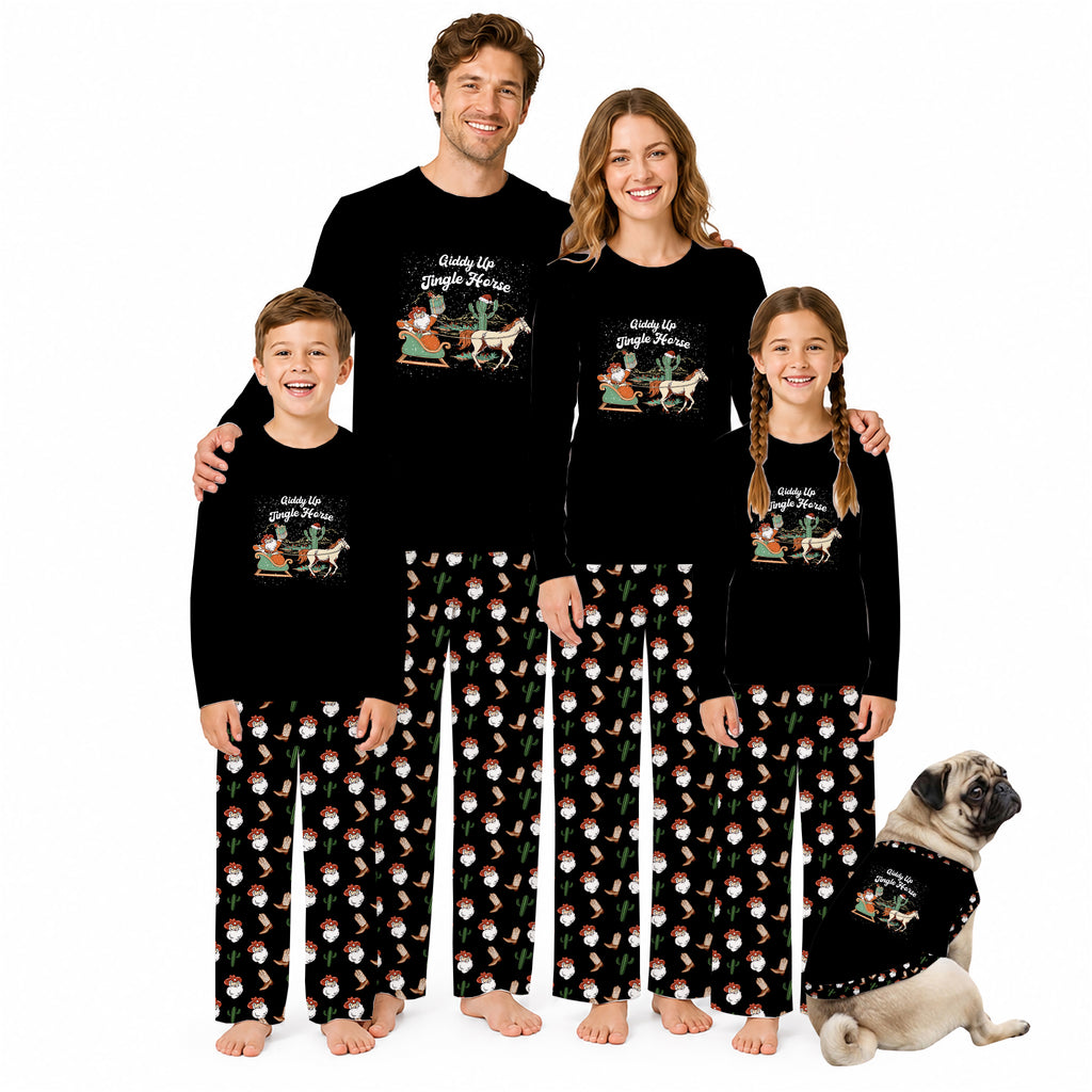 A family of four wearing matching black long-sleeve pajamas with a Christmas-themed graphic on the chest and a red-and-white Santa pattern on the pants, standing barefoot against a white background with a small dog beside them.