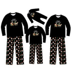 A matching family pajama set displayed on a white background, including three long-sleeve shirts and three pairs of pants in different sizes. The shirts are black with a colorful graphic of Santa riding a sleigh, and the pants feature a black background with a repeating pattern of Santa, reindeer, and snowflakes.