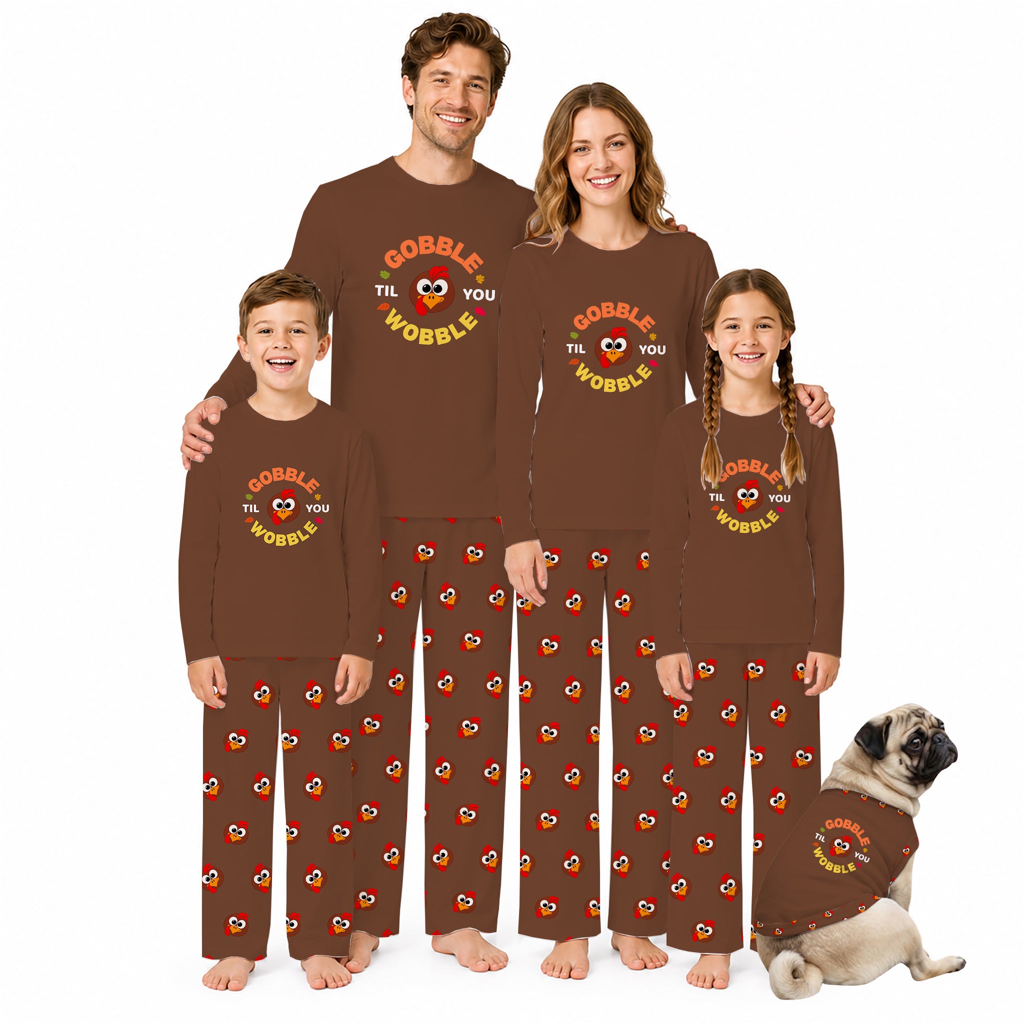 A family of four wearing matching brown long-sleeve pajamas with a 'COBBLE THE WOBBLE' graphic and Red-and-yellow heart pattern, standing on a White background with a small dog at the bottom right.