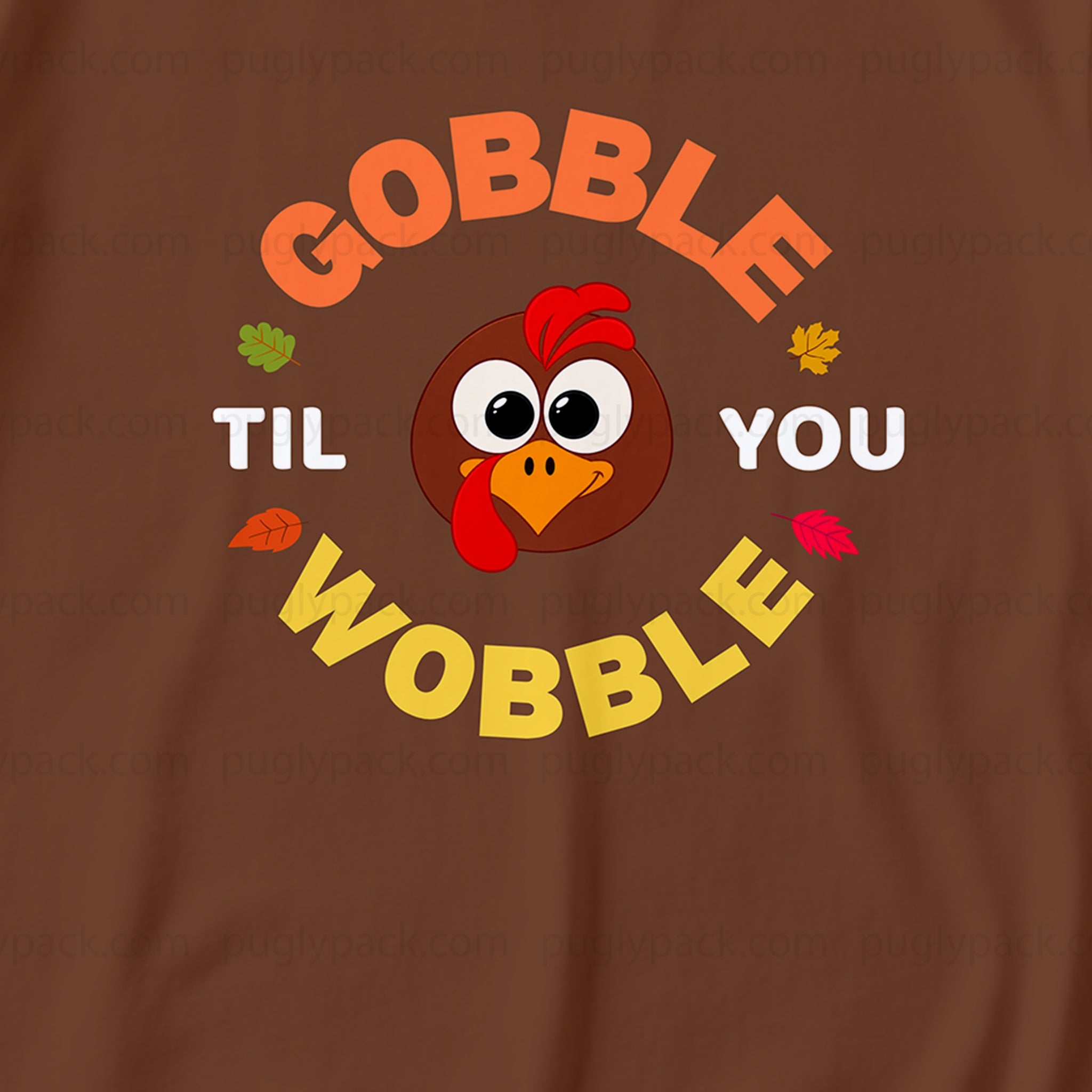 A close-up of a brown garment featuring a colorful graphic print with the text 'GOBBLE TIL YOU WOBBLE' and a cartoon turkey face in the center.