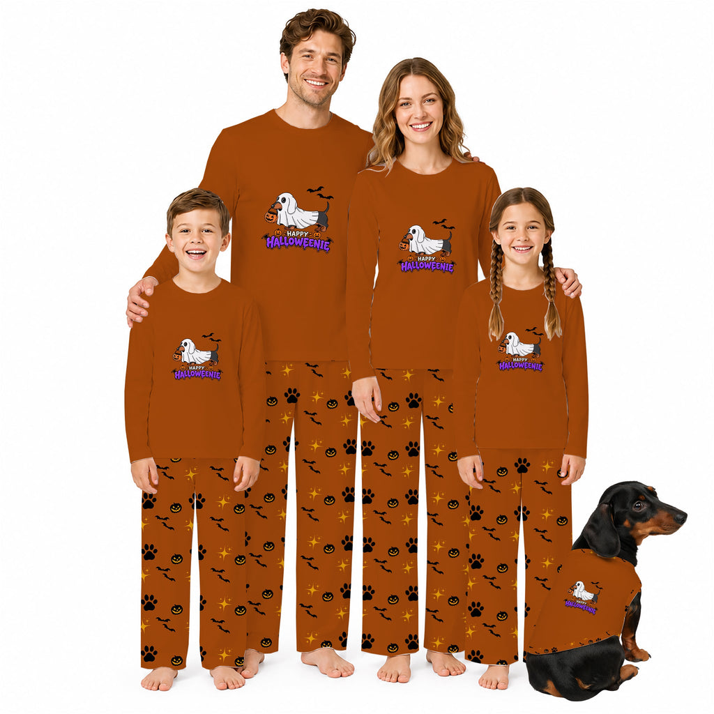 A family of four and a dog wearing matching Halloween-themed long-sleeve pajamas. The pajamas are rust brown with Black and orange pumpkin and bat patterns, and feature a White dachshund graphic with Purple 'Halloween Dog' text.