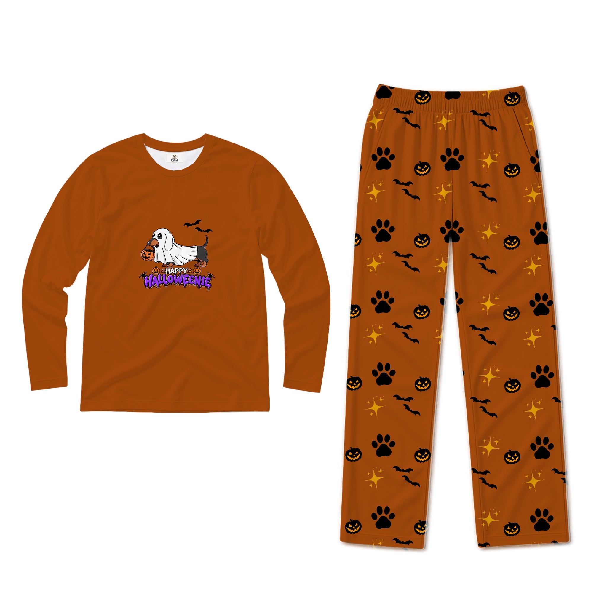 A two-piece Halloween pajama set on a White background, featuring a long-sleeve crewneck shirt in burnt orange with a cartoon dog graphic and 'Happy Halloween' text, and matching pants in the same burnt orange fabric with a pattern of Black paw prints, jack-o'-lanterns, bats, and stars.