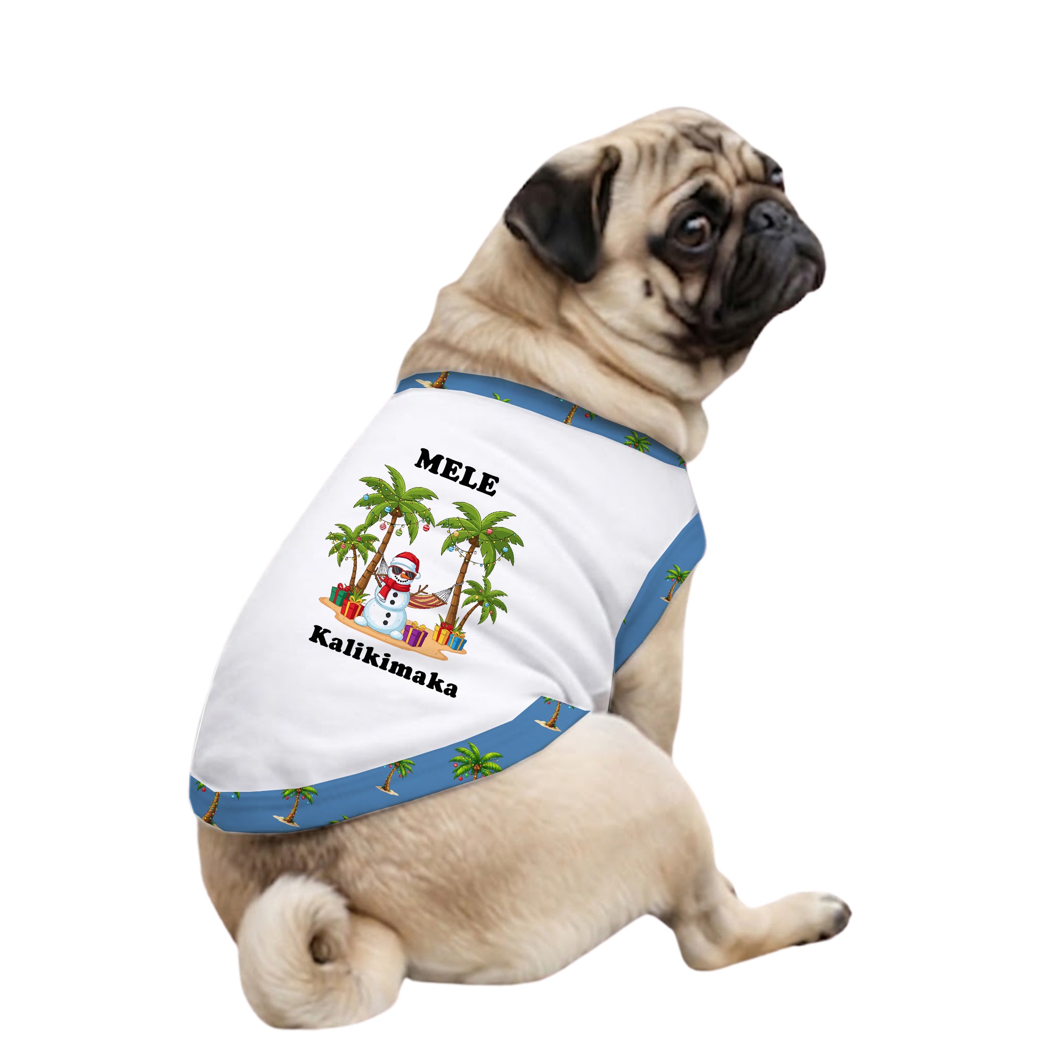 A fawn pug dog wearing a white pet shirt with blue trim and a tropical beach graphic. The shirt features the text 'MELE' and 'Kalikimaka' with an illustration of palm trees, a sandcastle, and a sun.