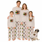 A family of four wearing matching Christmas-themed long-sleeve pajamas stands together on a White background, with a small dog sitting at their right. Each person wears a light Beige pajama top with a colorful holiday graphic and the words 'Merry Christmas,' plus matching patterned pajama pants.