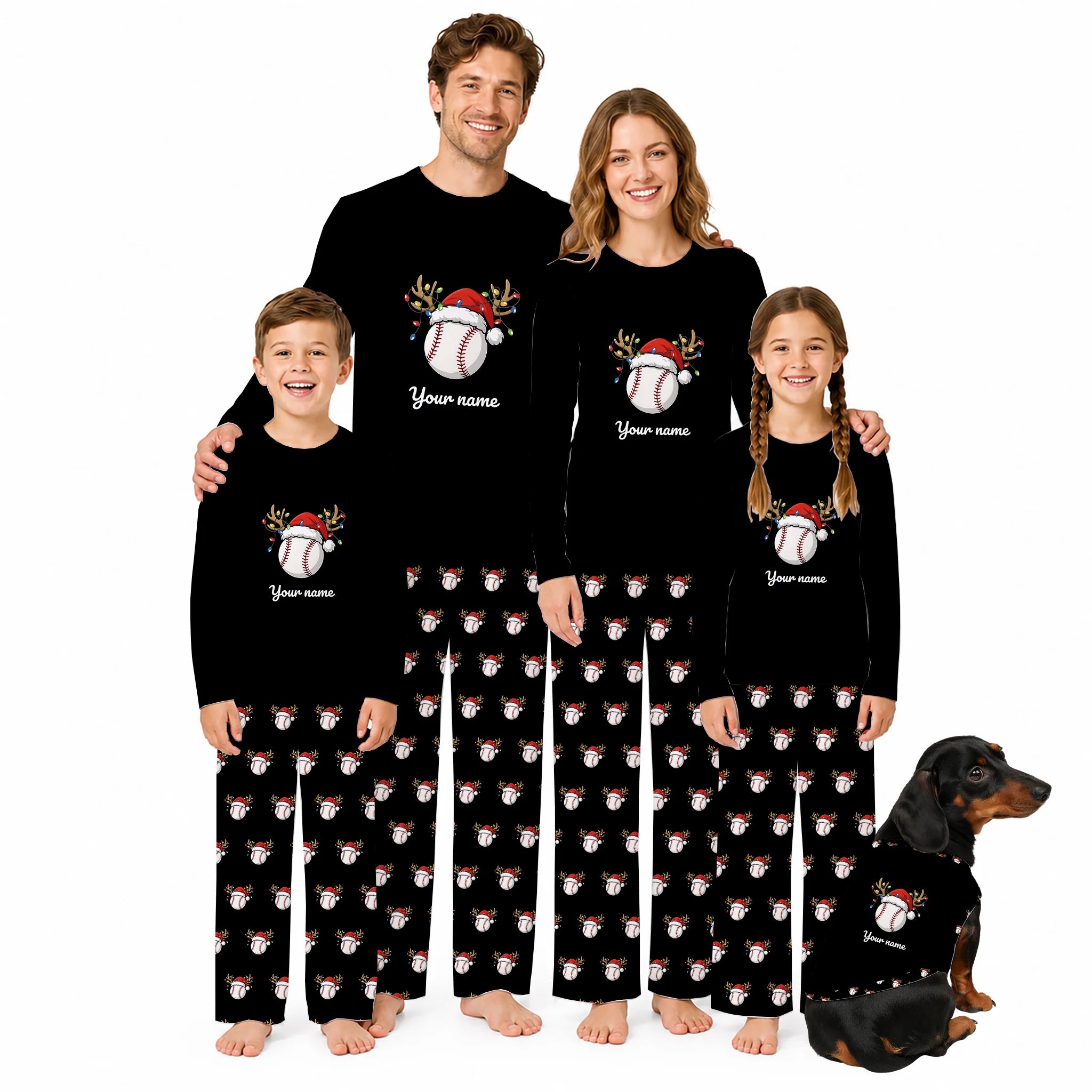 A family of four wearing matching black long-sleeve pajamas with a baseball-themed Christmas graphic and holiday print pants, posed with a dachshund on a plain white background.