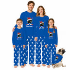 A family of four wearing matching royal blue pajamas with a hockey-themed graphic and white skater silhouettes, plus a small dog in a matching pajama shirt, on a plain white background.